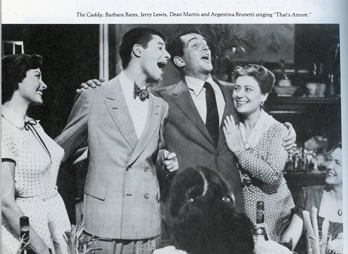 A still from the movie, The Caddy, showing a scene in which Jerry Lewis, Dean Martin, Barbara Bates, and Argentina Brunetti sing the song, "That's Amore."